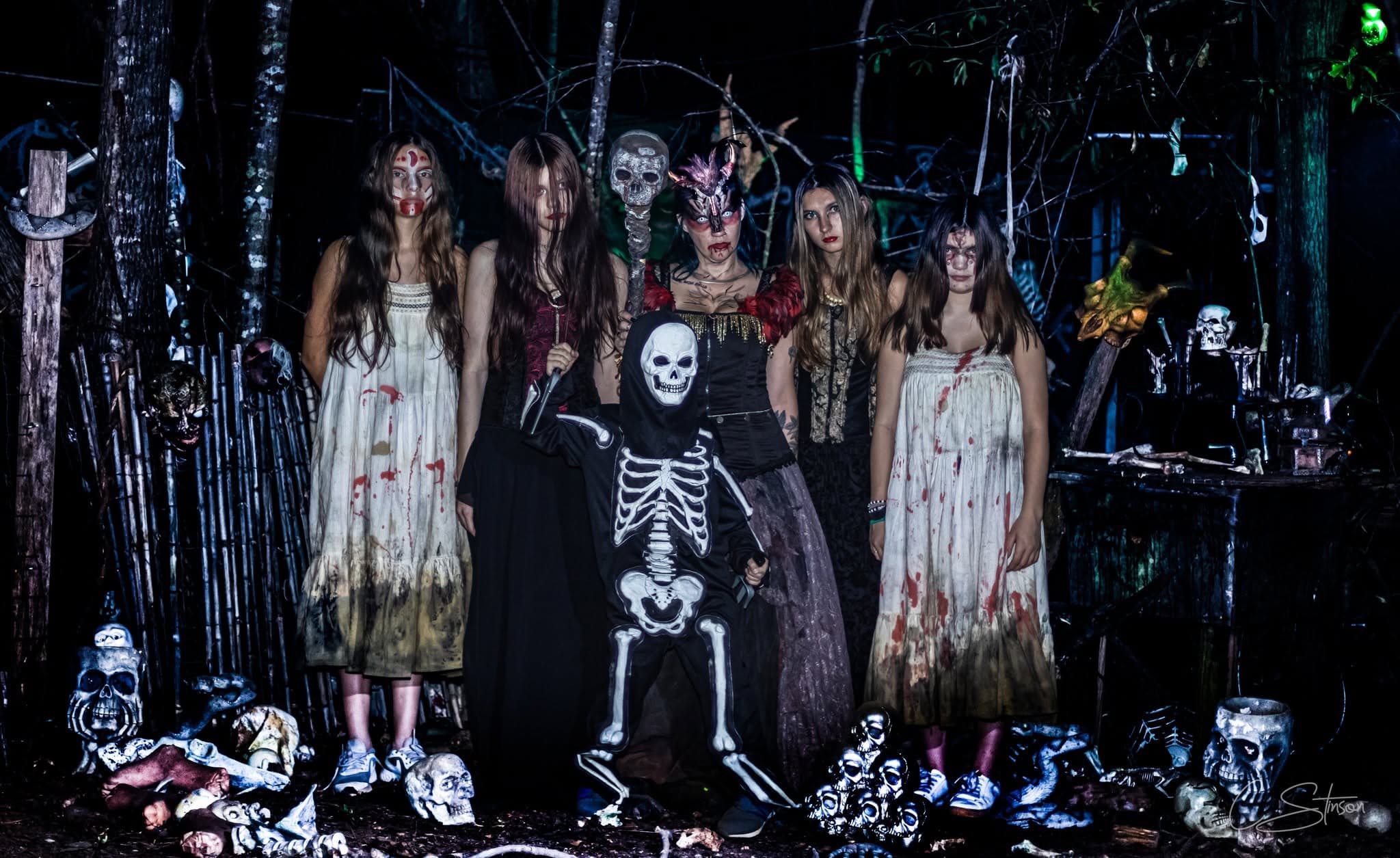 Creepy Hollow Woods cast members in a wooded scene